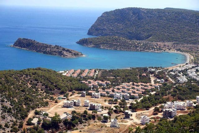 Paddle board by rocks